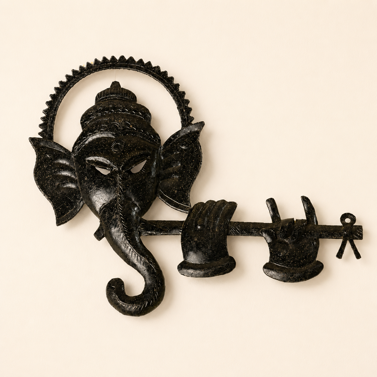 Bastar wrought iron Ganesh wall panel with toothed halo and flute on an ivory background