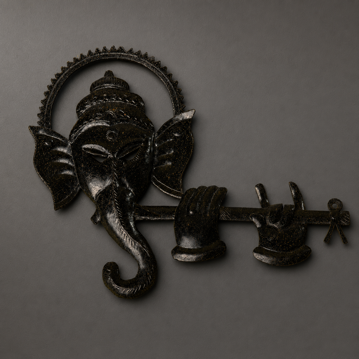 Craft detail of the engraved crown, ears, trunk, hands and patina of a Ganesh wall panel