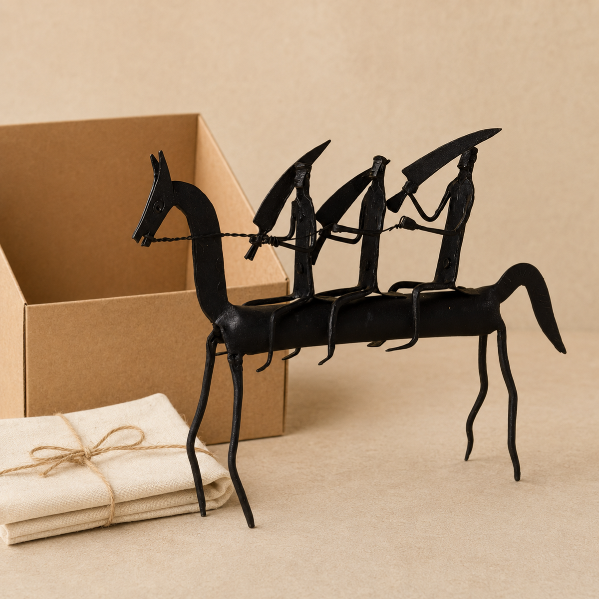 Bastar wrought iron horse-and-riders figurine presented beside a kraft gift box