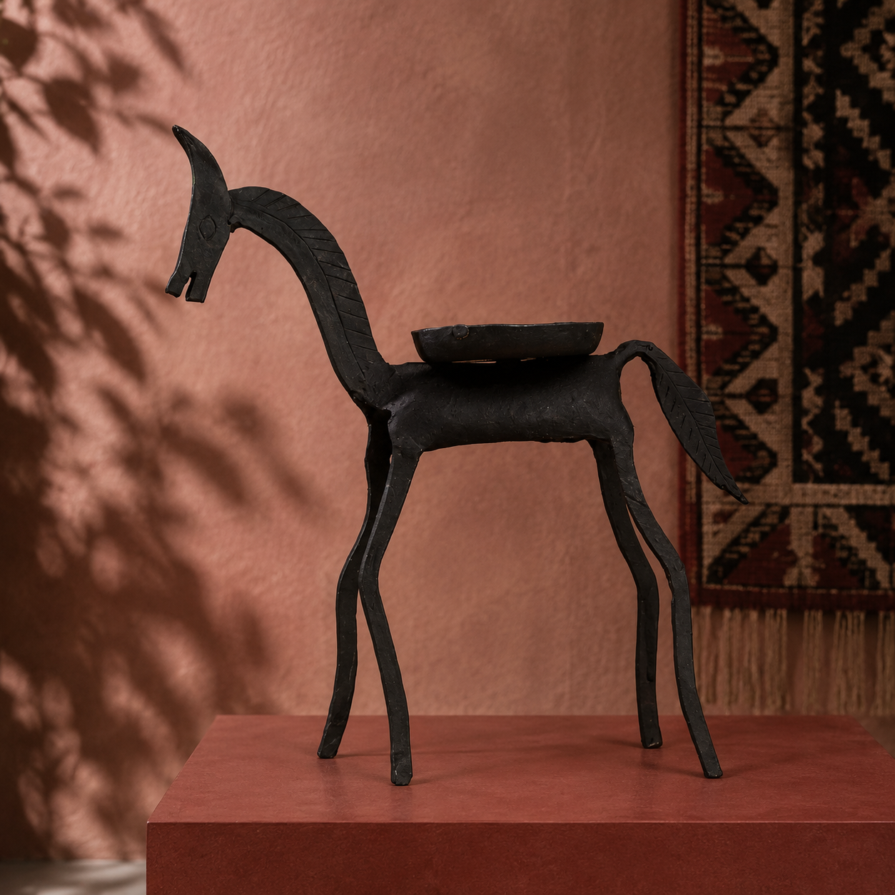 Hand-forged Bastar iron horse displayed in an ochre artisan-inspired interior