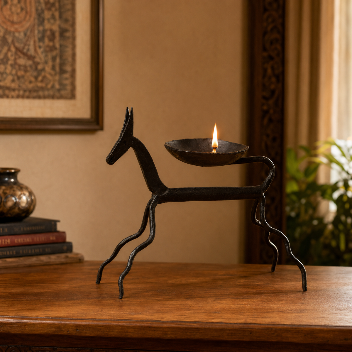 Bastar Wrought Iron Horse Oil Lamp glowing on a contemporary teak console