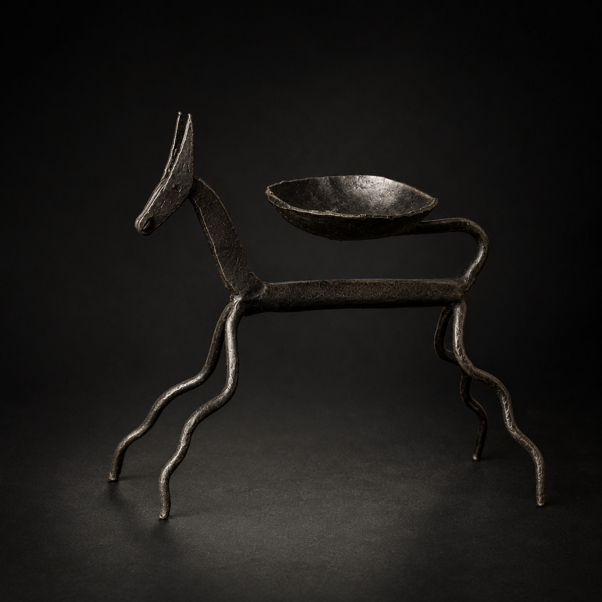 Detailed view of the hand-forged horse, looped tail and diya bowl