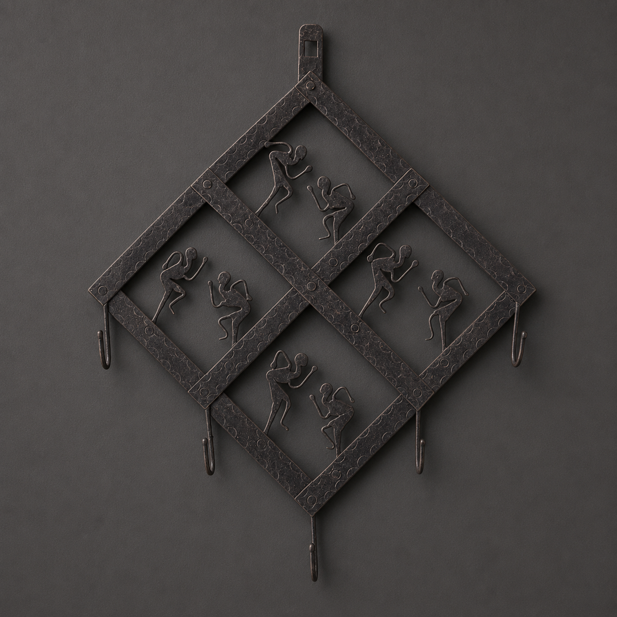 Detailed view of the riveted diamond lattice, dancers and five hooks of a Bastar iron key hanger