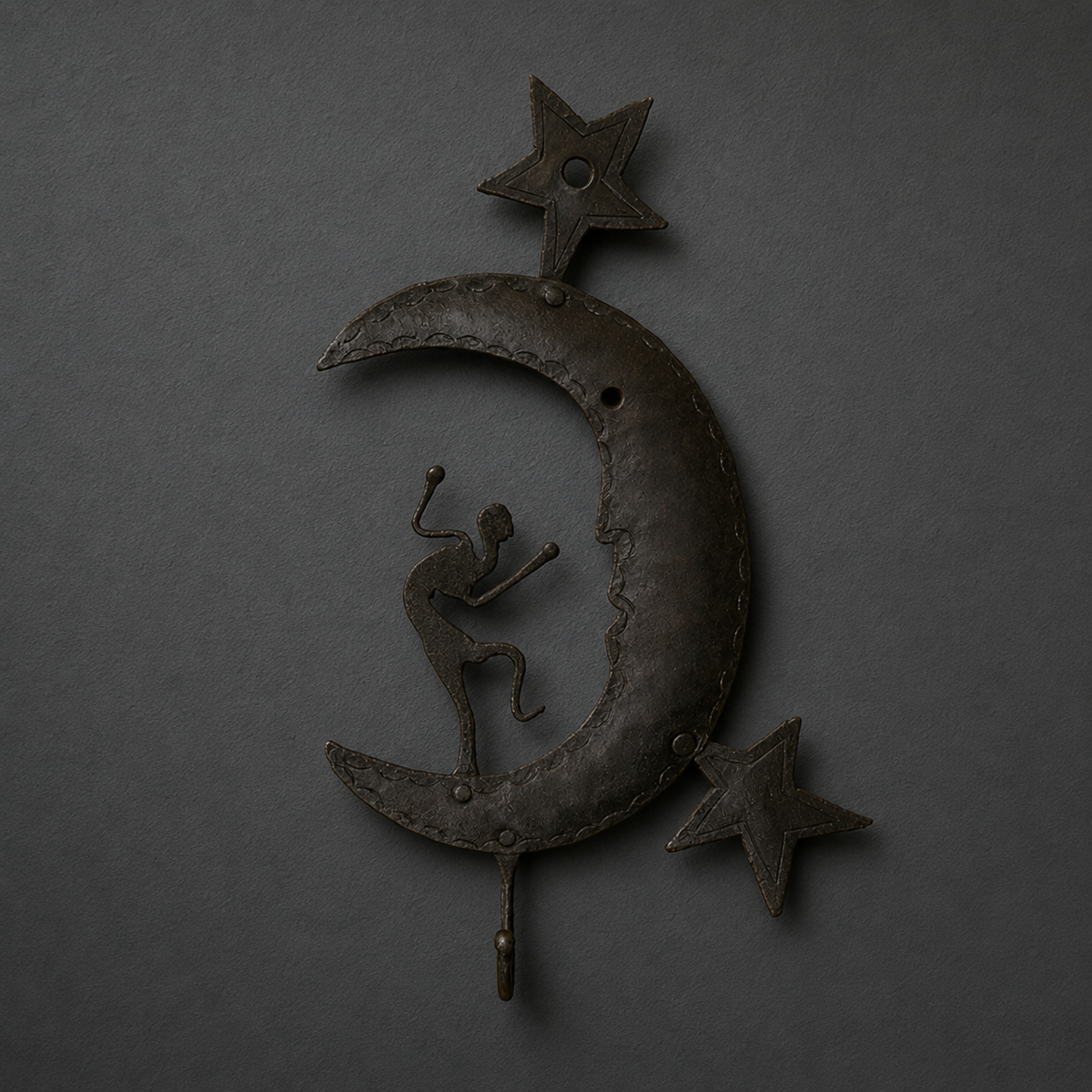 Detailed view of the rivets, scalloped edging and dancer silhouette on a Bastar iron key hanger
