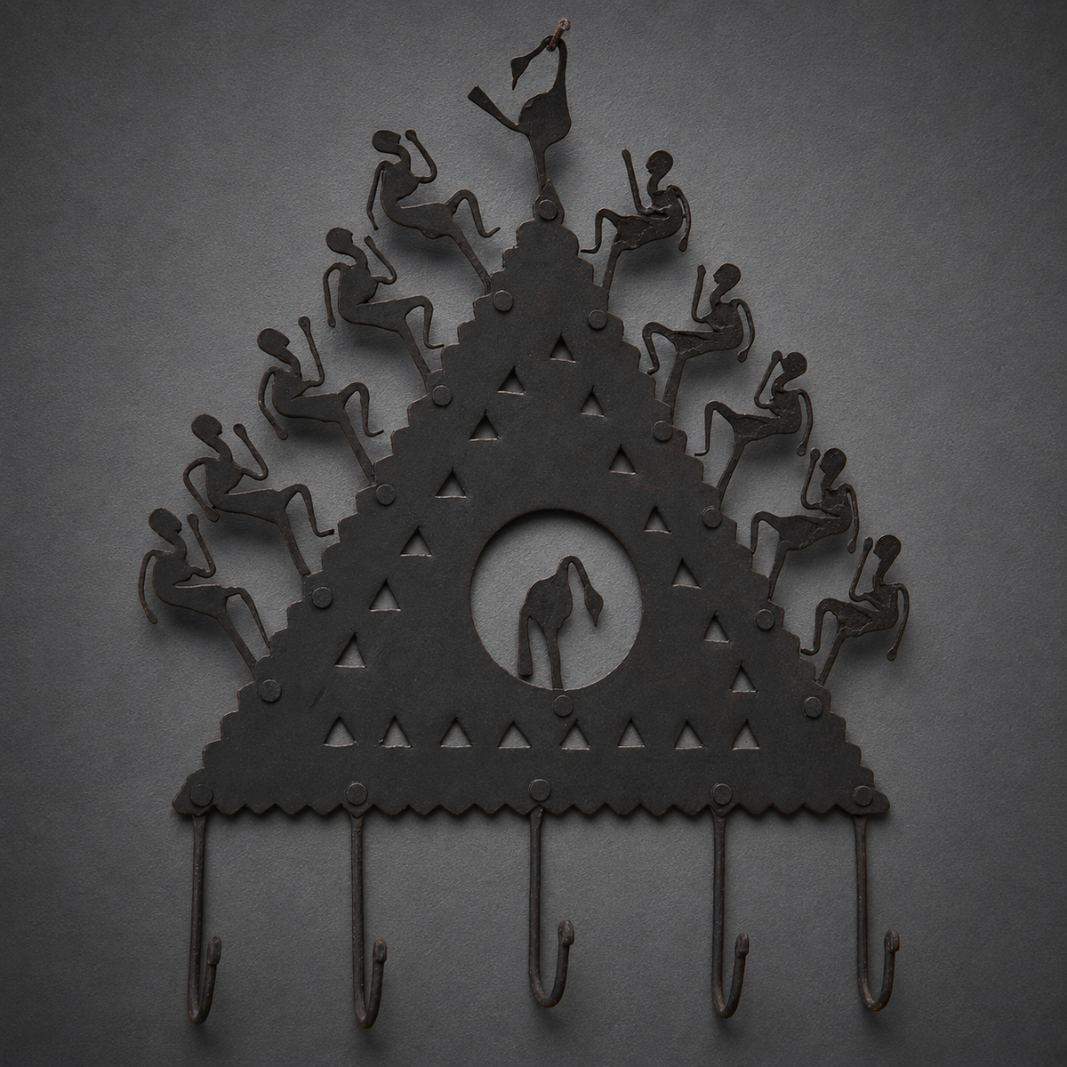Detailed view of forged figures, rivets, cut-outs and five hooks on a Bastar key hanger