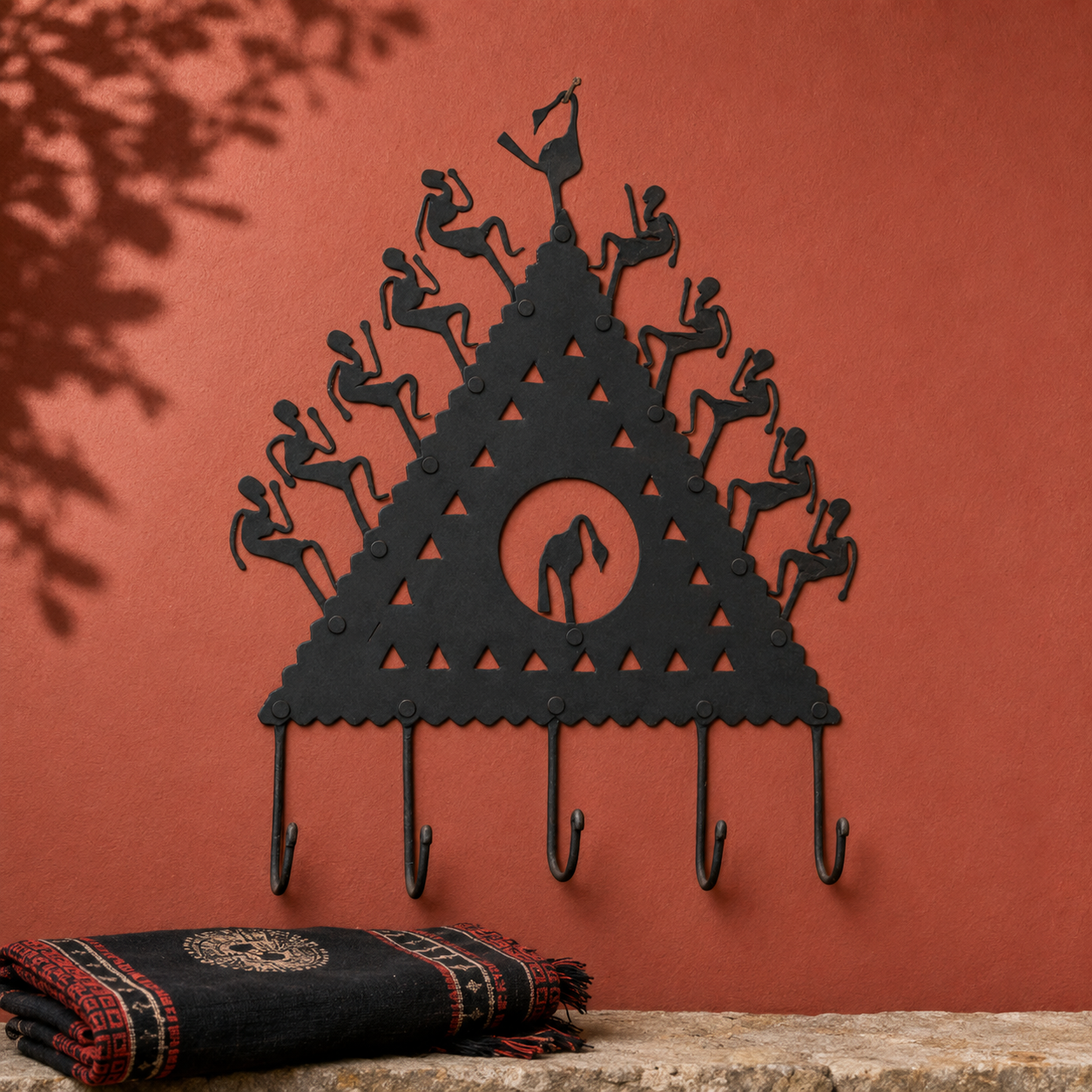 Tribal wrought iron key hanger displayed on a terracotta craft editorial wall