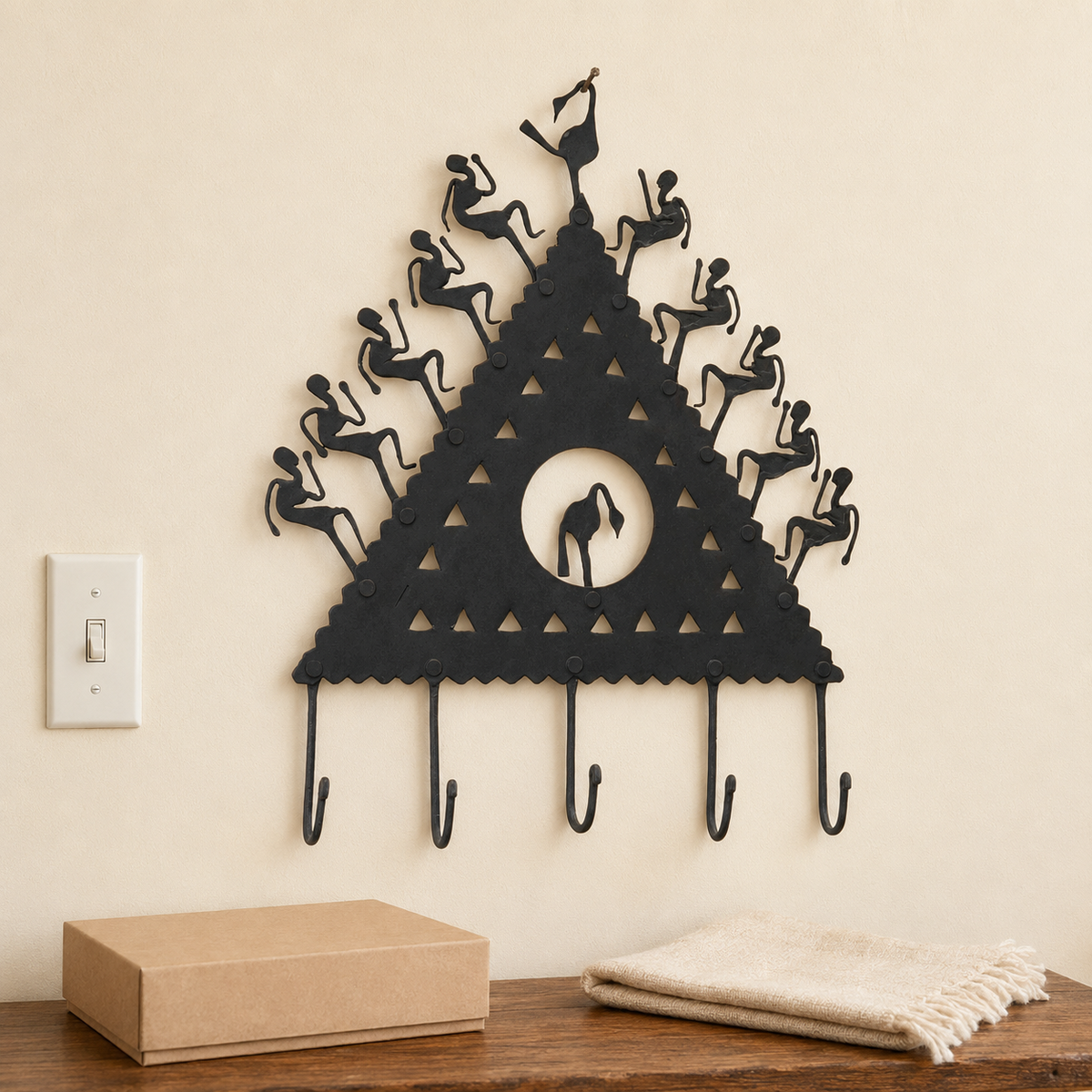 Bastar wrought iron key hanger shown at wall scale above a kraft gift box