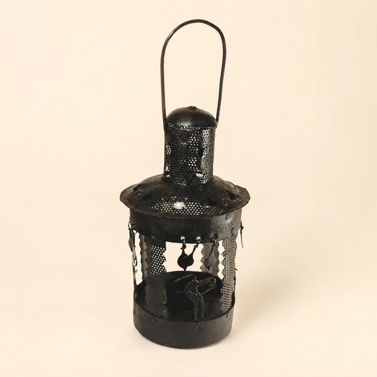 Bastar wrought iron lantern on a clean warm ivory studio background