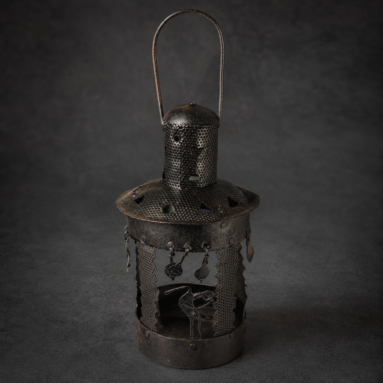 Detailed view of the perforated metalwork and hanging ornaments on a Bastar lantern