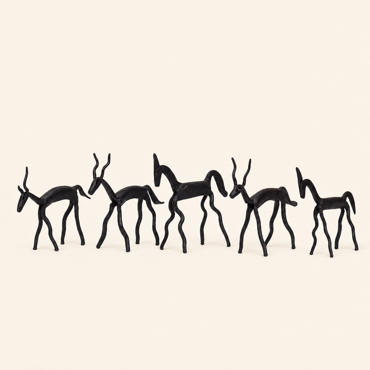 Five-animal Bastar wrought iron miniature on a warm ivory catalogue background