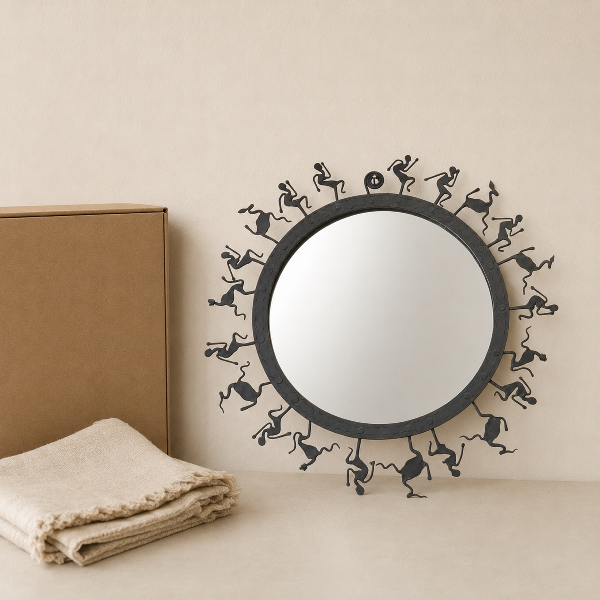 Hand-forged Bastar wrought iron tribal mirror frame presented beside a gift box and folded cloth