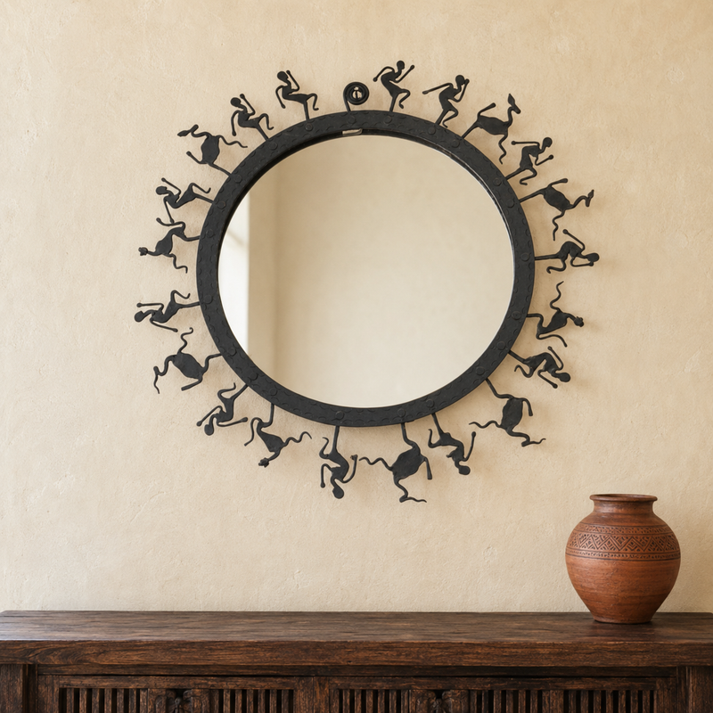 Bastar wrought iron tribal mirror displayed above a wooden console in a warm interior