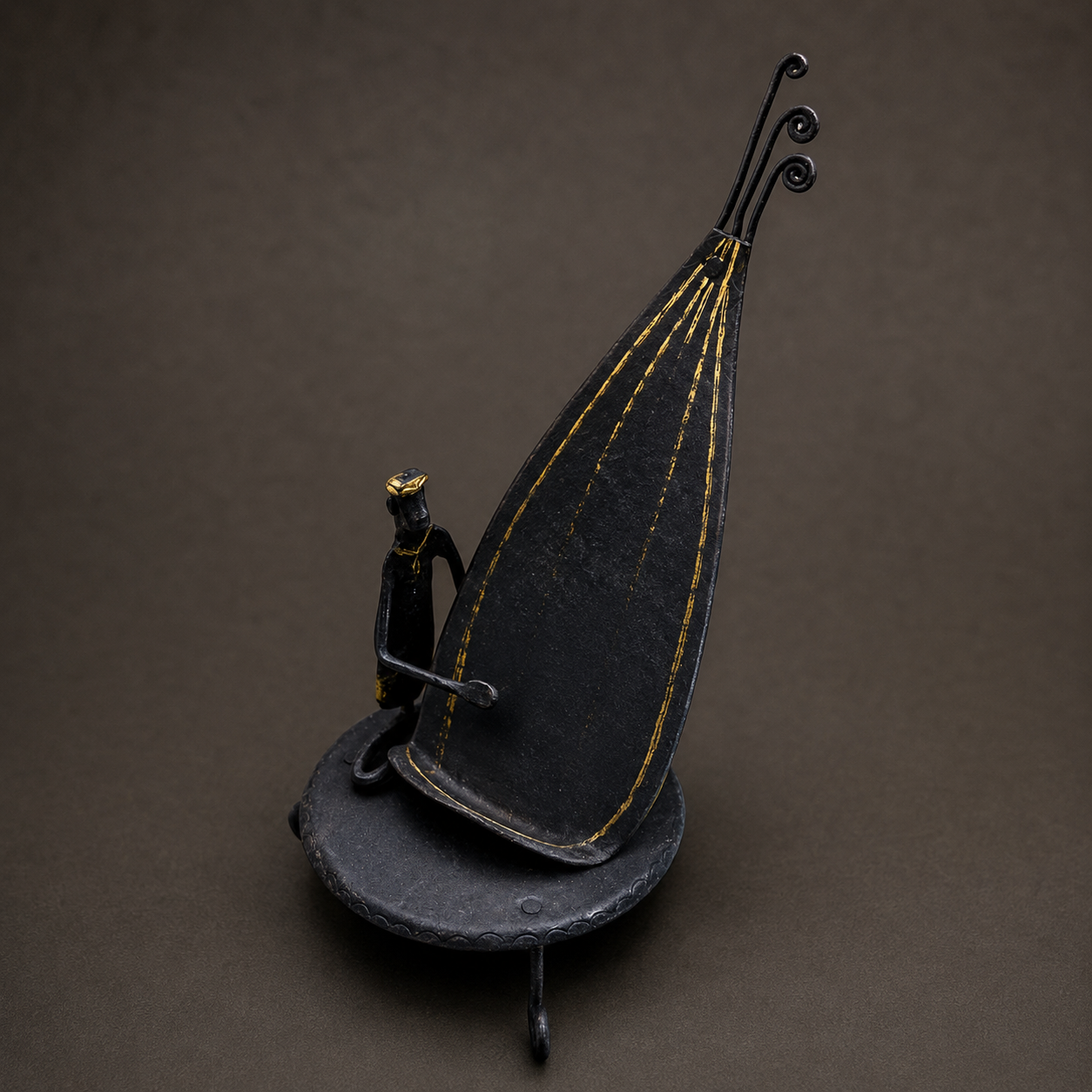 Detailed view of the hand-forged mobile holder, spiral stems and gold accents