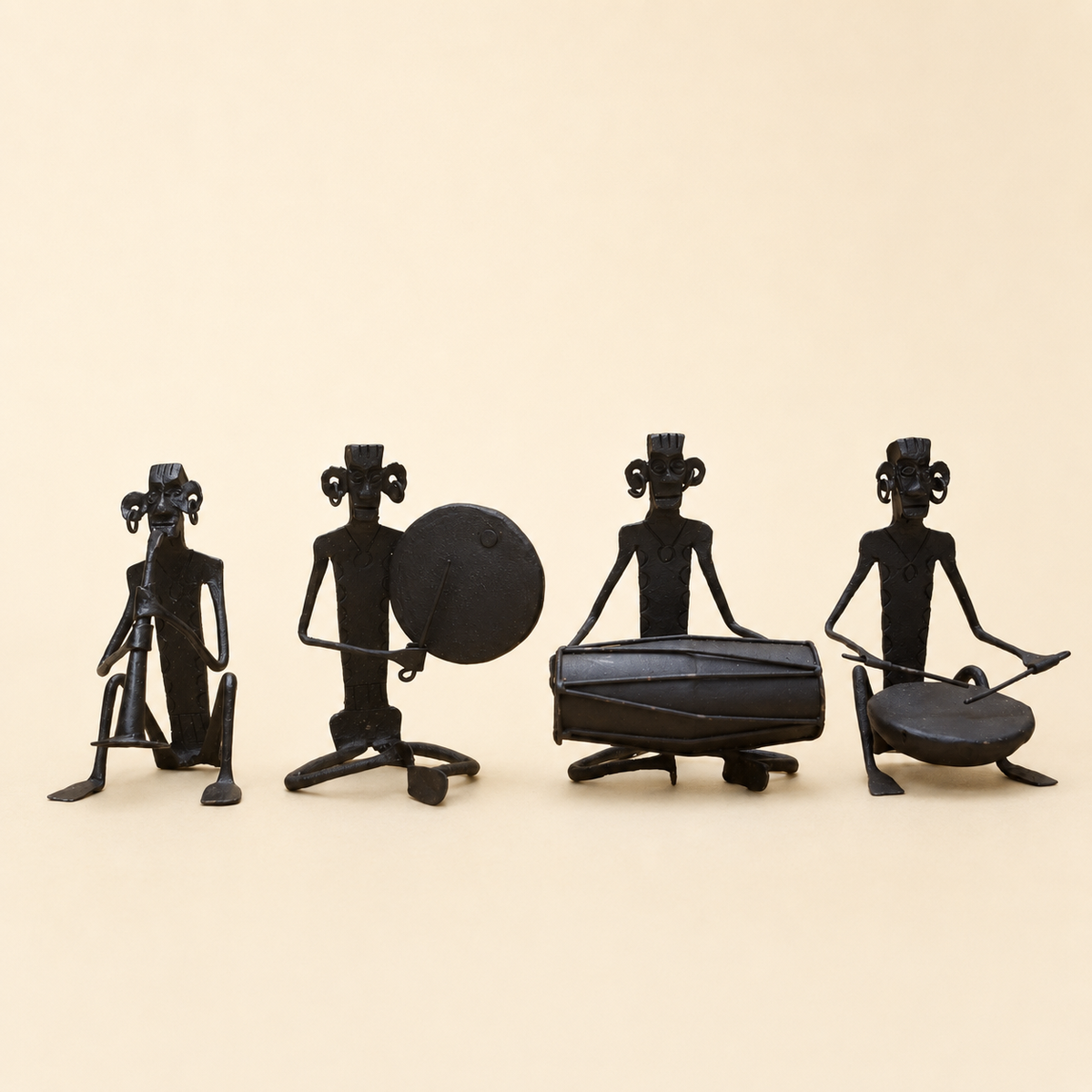 Four-piece Bastar wrought iron musician set on a warm ivory catalogue background