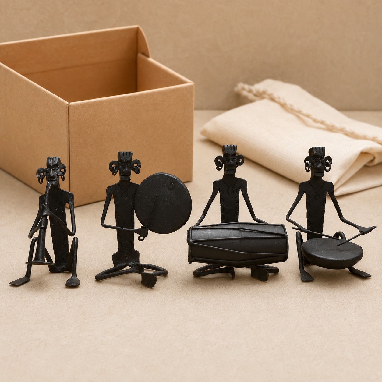 Four-piece Bastar wrought iron musician set presented beside a kraft gift box
