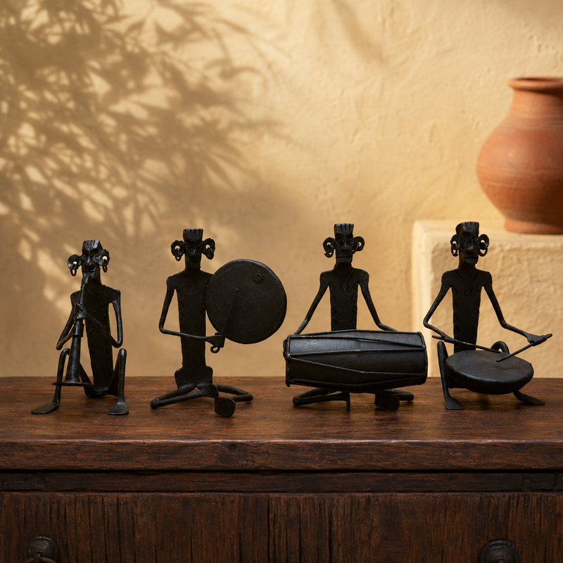 Bastar wrought iron musician ensemble displayed on a wooden console in a warm interior