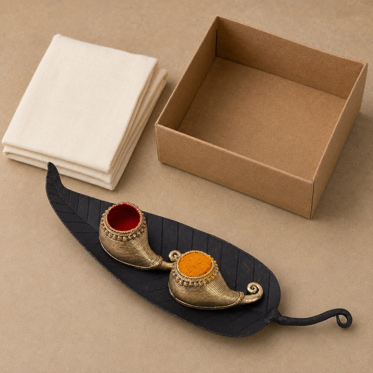 Bastar wrought iron sindoor holder arranged beside a kraft gift box and cotton wrap