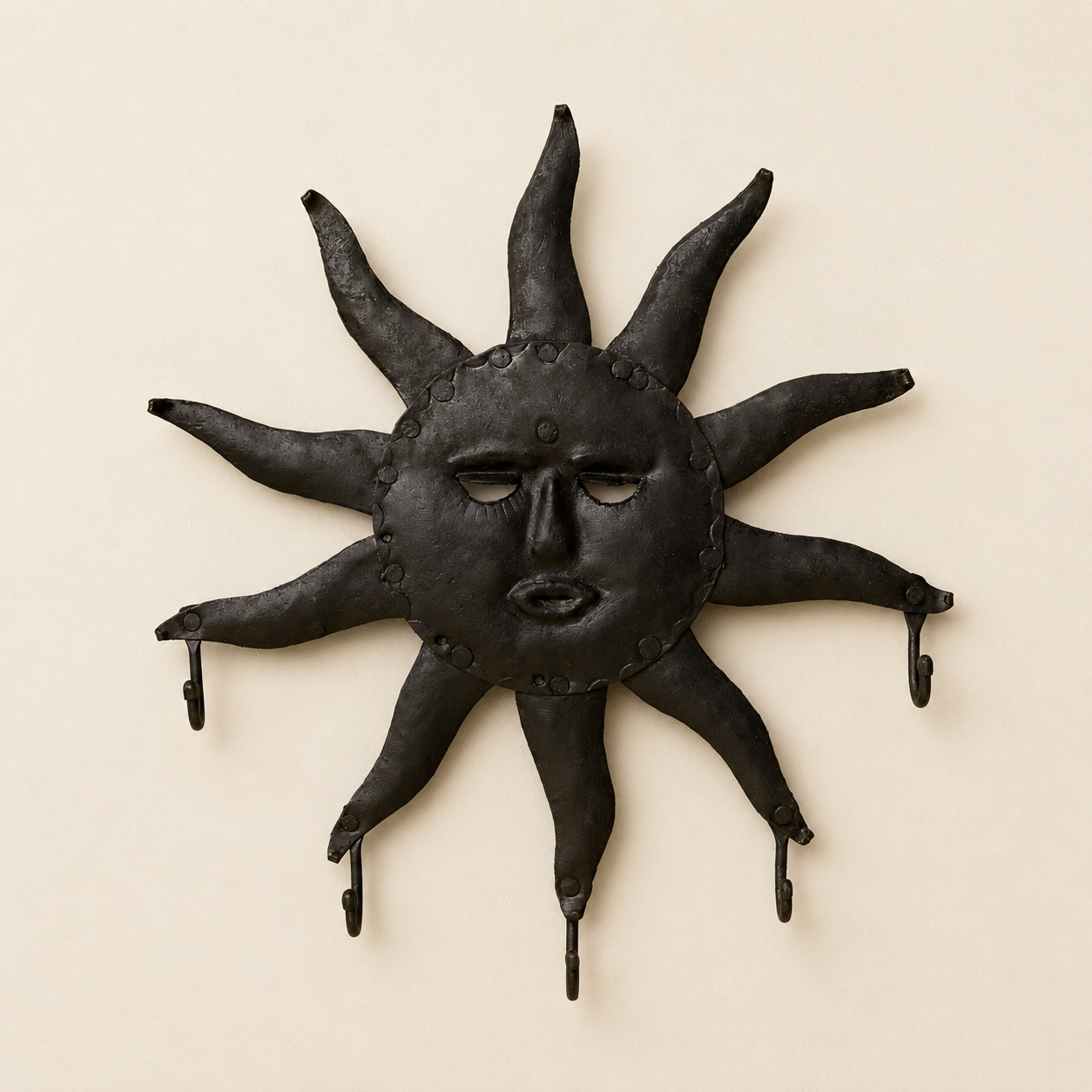 Bastar wrought iron sun key hanger with ten rays and five hooks on an ivory wall