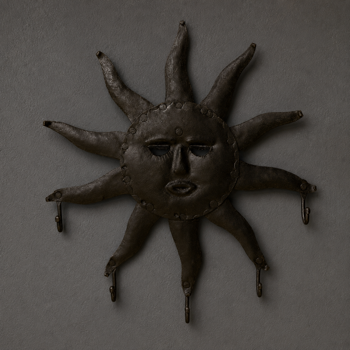 Detailed view of the face, rivets, ten rays and five hooks of a Bastar iron key hanger