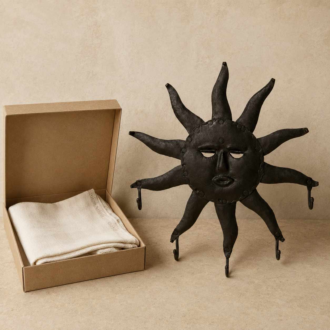 Bastar wrought iron sun key hanger with five hooks beside an open gift box