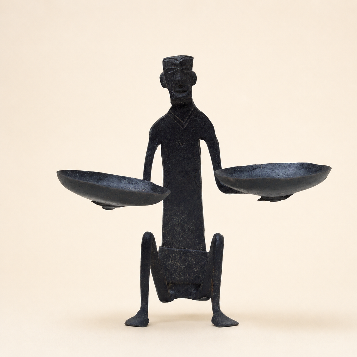 Bastar wrought iron tribal figure candle holder with two bowls on an ivory background