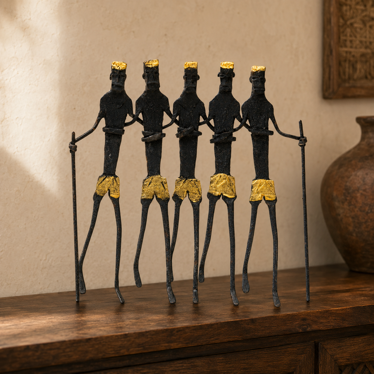 Five-figure Bastar wrought iron tribal sculpture displayed on a wooden console