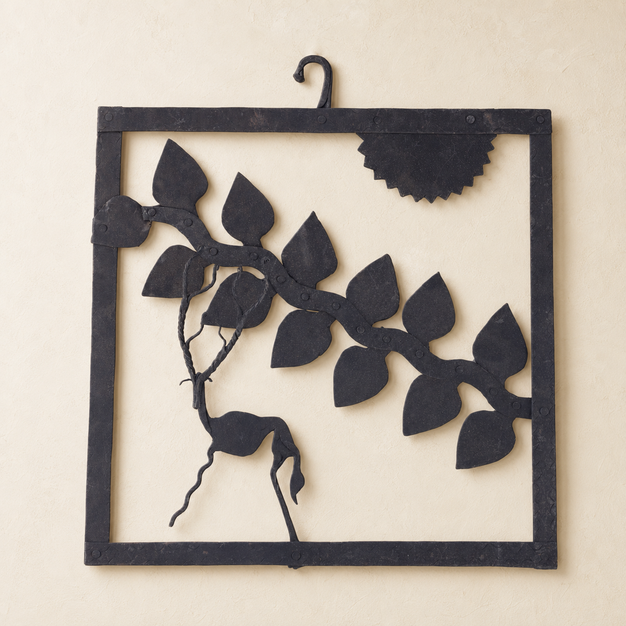 Bastar wrought iron deer and leafy branch wall decor on a warm ivory wall