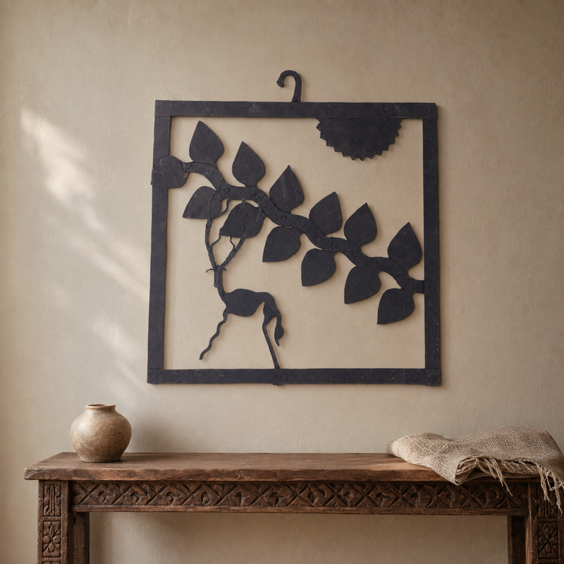 Bastar wrought iron deer wall hanging displayed above a carved wooden console